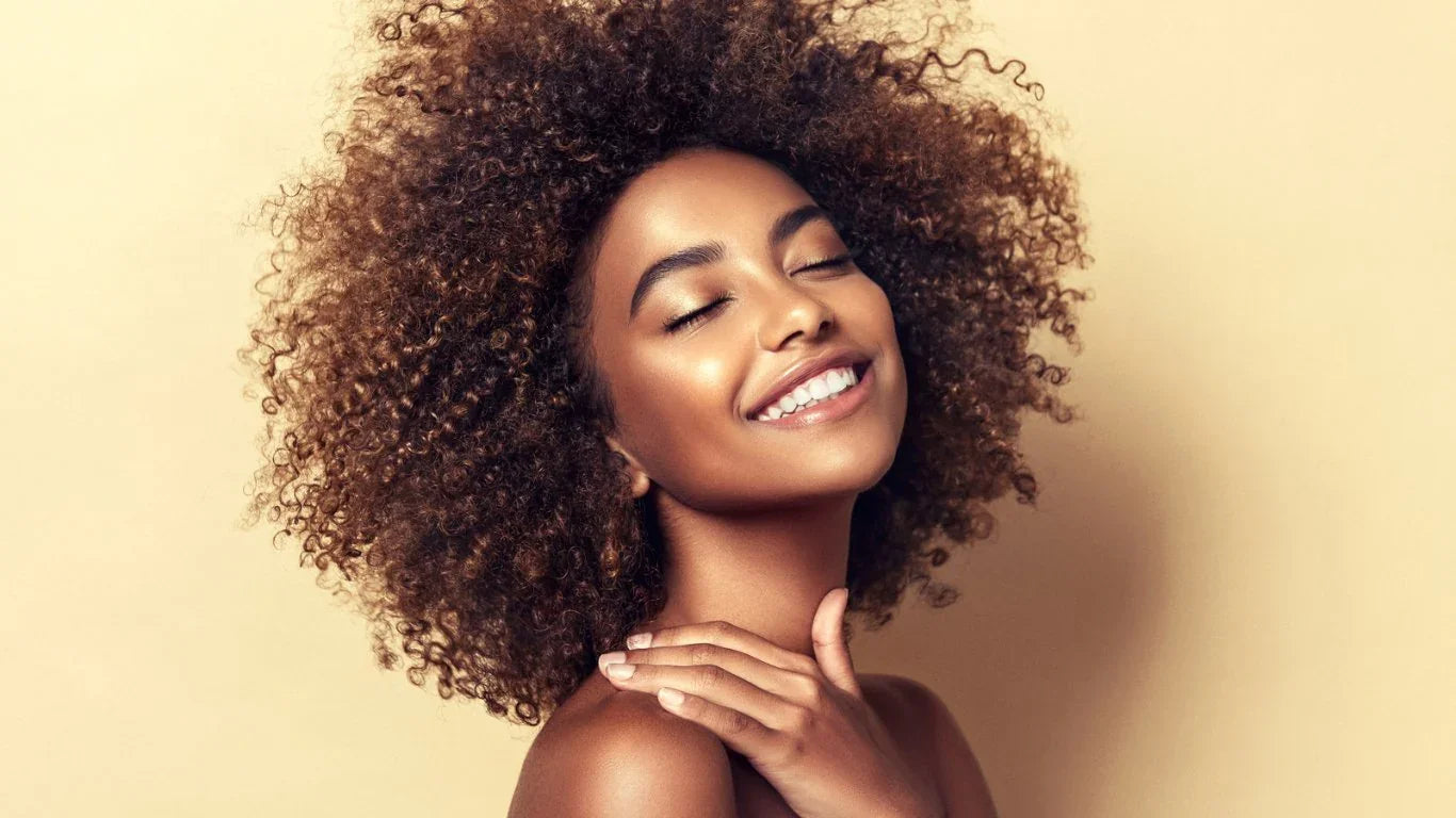 Jeune femme heureuse avec peau éclatante et cheveux bouclés sur fond beige, soins de la peau haut de gamme